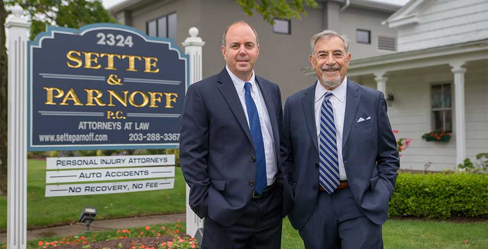 photo of attorneys David V. Parnoff and Fred Sette in front of their office